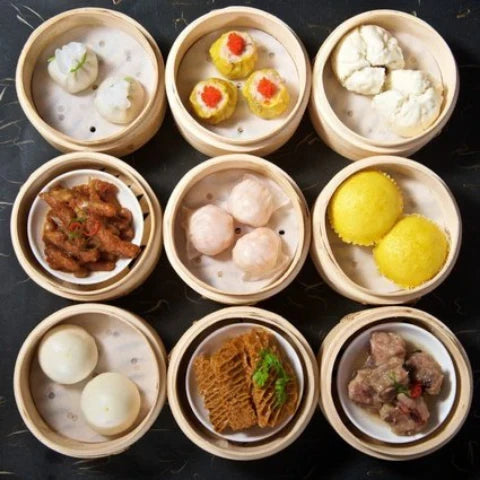 A delicious array of top dim sum dishes to try 🍜, featuring shrimp dumplings, siu mai, buns, and more!