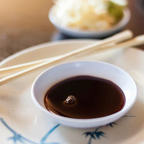 Essential Asian cooking ingredients: soy sauce in a bowl with chopsticks ready for cooking Asian dishes 🍜🧧.
