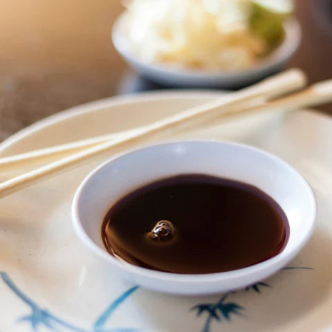 Essential Asian cooking ingredients: soy sauce in a bowl with chopsticks ready for cooking Asian dishes 🍜🧧.