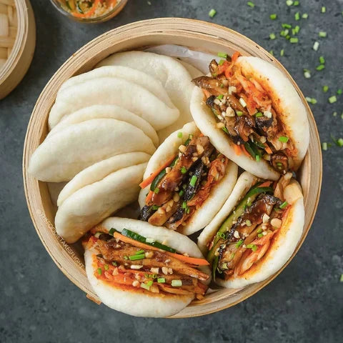 Steamed bao buns filled with delicious veggies and sauce, showcasing the light and fluffy bao buns recipe.